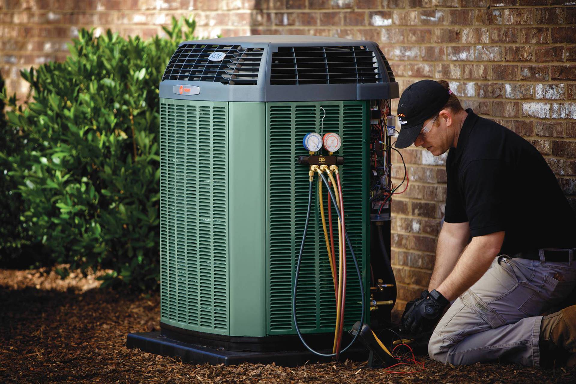 A technician working on an AC unit.